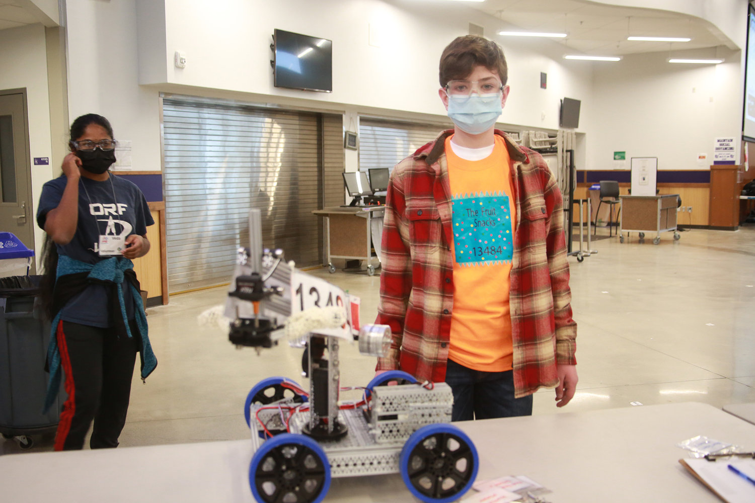 Derrik Yasson, a student from Capital High School, poses next to his robot.